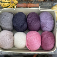 Eight balls of Milburn 4ply in shades of pink, grey and purple