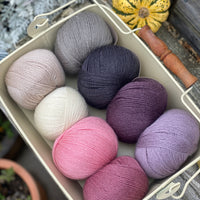 Eight balls of Milburn 4ply in shades of pink, grey and purple