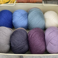 Eight balls of Milburn 4ply in shades of blue and purple