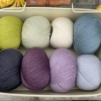 Eight balls of Milburn 4ply in shades of purple, blue and green