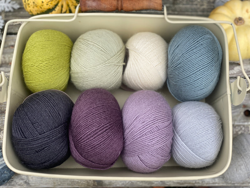 Eight balls of Milburn 4ply in shades of purple, blue and green