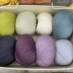 Eight balls of Milburn 4ply in shades of purple, blue and green