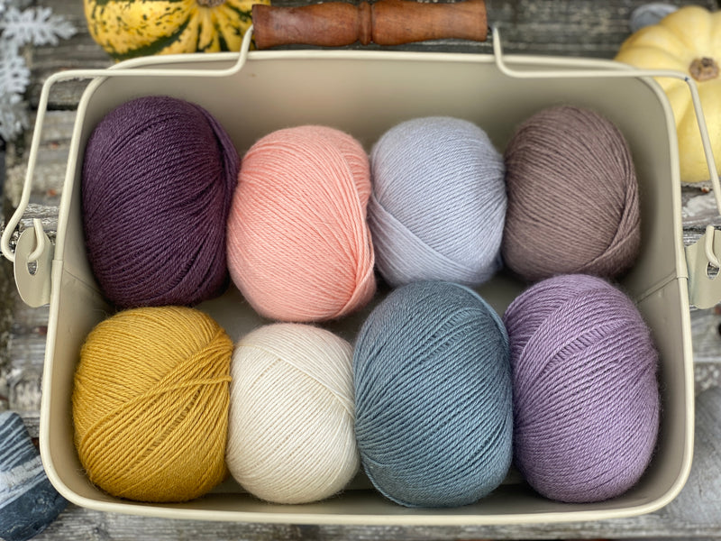 Eight balls of Milburn 4ply in shades of purple, blue and brown