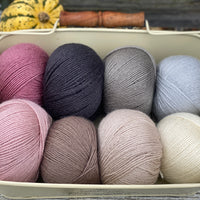 Eight balls of Milburn 4ply in shades of pink, brown and grey