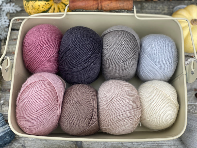 Eight balls of Milburn 4ply in shades of pink, brown and grey