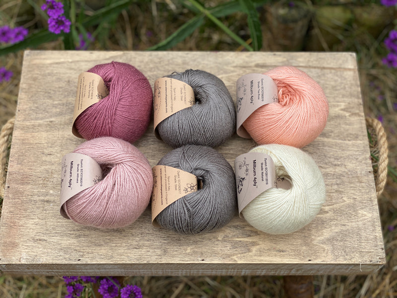 Six balls of yarn in grey and pinks