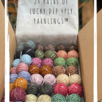 A box of 24 Yarnling pairs. Text at the top of the image is "24 pairs of Lucky Dip 4ply Yarnlings"