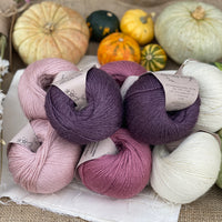 Eight balls of Milburn 4ply in shades of pink, purple and cream