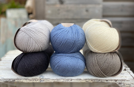 Ten balls of Milburn in shades of grey with a pop of blue