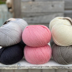 10 balls of Milburn in shades of grey with a pop of pink