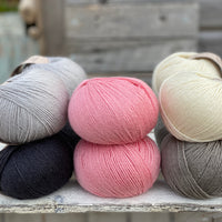 10 balls of Milburn in shades of grey with a pop of pink