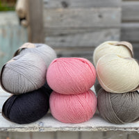 10 balls of Milburn in shades of grey with a pop of pink