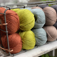 Twenty balls of Milburn in shades of brown, green and grey