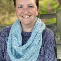 Victoria wearing a blue Swainby Cowl and a purple jumper