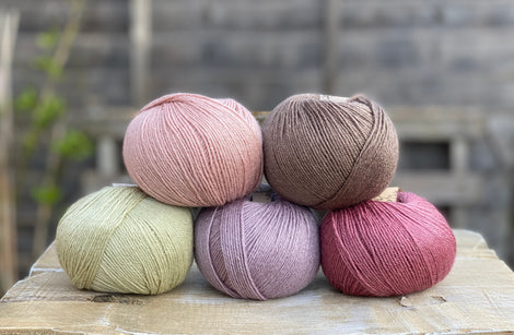 Five balls of Milburn in shades of pink, purple, green and brown