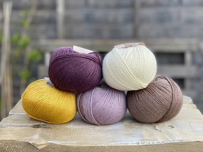 Five balls of Milburn in shades of purple, cream, yellow and brown