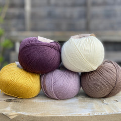 Five balls of Milburn in shades of purple, cream, yellow and brown