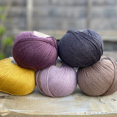 Five balls of Milburn in purple, black , brown and yellow