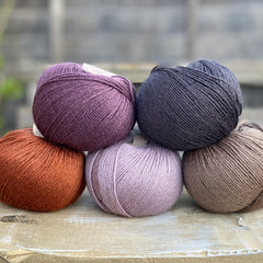 Milburn 4ply in shades of purple, black, brown and rust