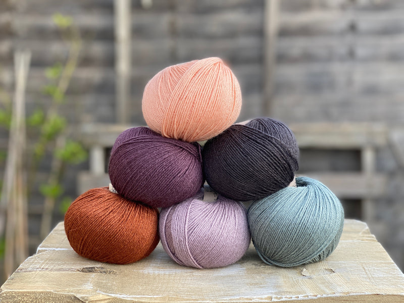 Six balls of yarn in coordinating colours