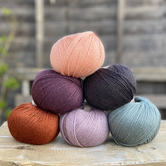 Six balls of yarn in coordinating colours