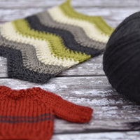 Black yarn alongside a sample of crochet