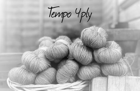 Black and white image of skeins of yarn with "Tempo 4ply" overlaid in black text